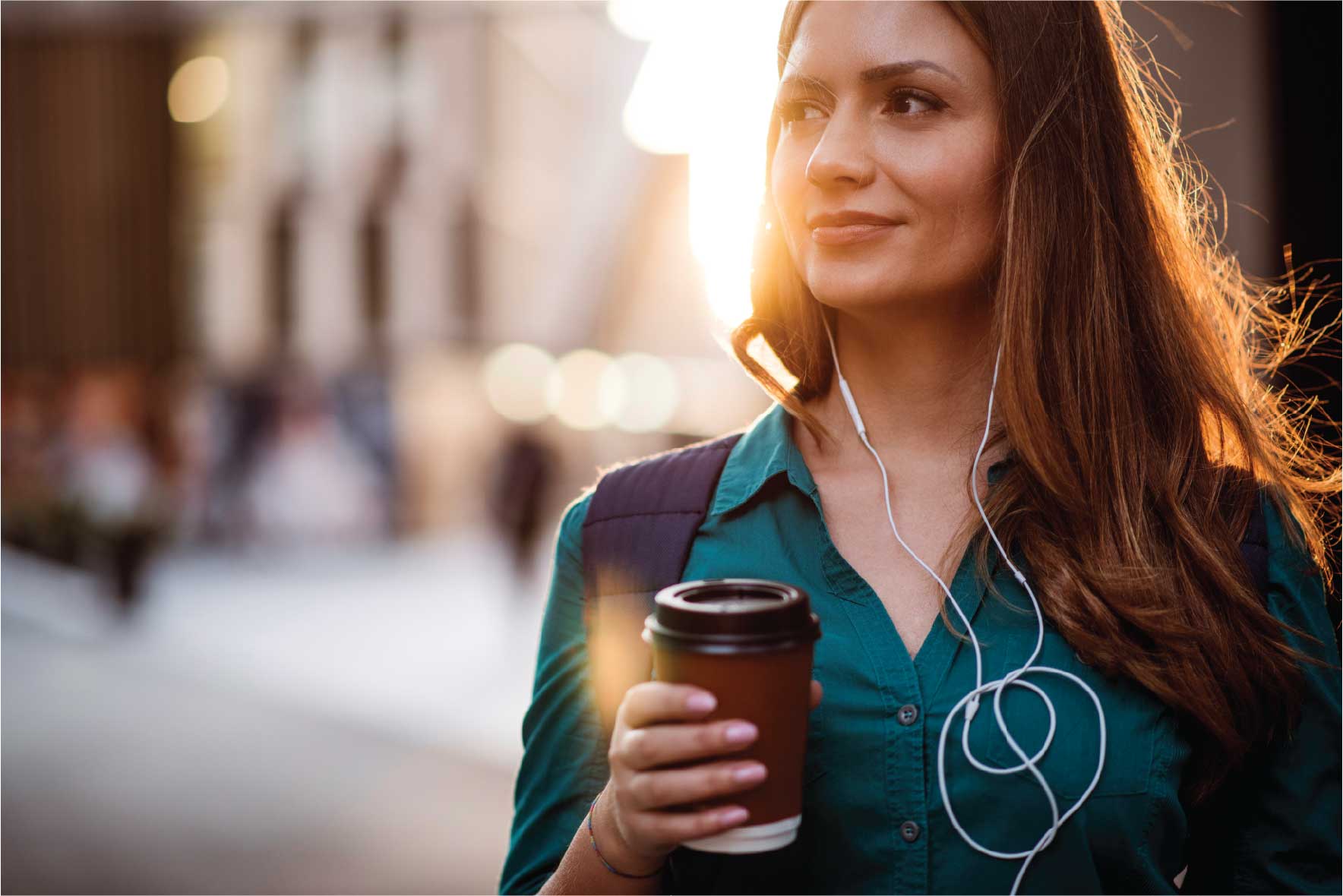 woman with earbuds and coffee